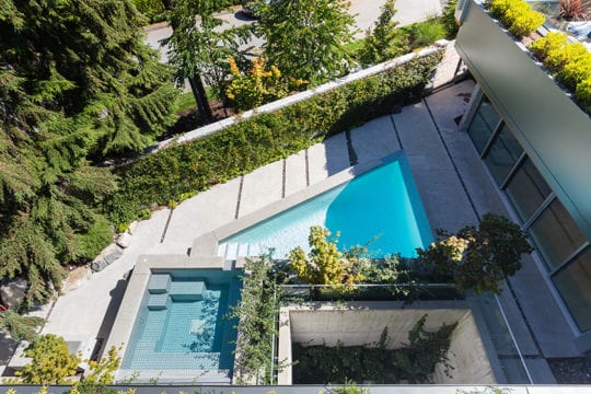 Bird's eye view of pool and hot tub in private, customized courtyard.