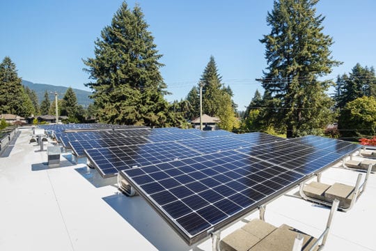 Solar panels on roof top, creating energy efficient power for custom Vancouver home.