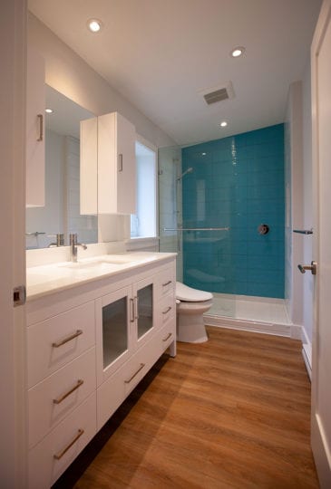 Bathroom with vanity, toilet and shower.