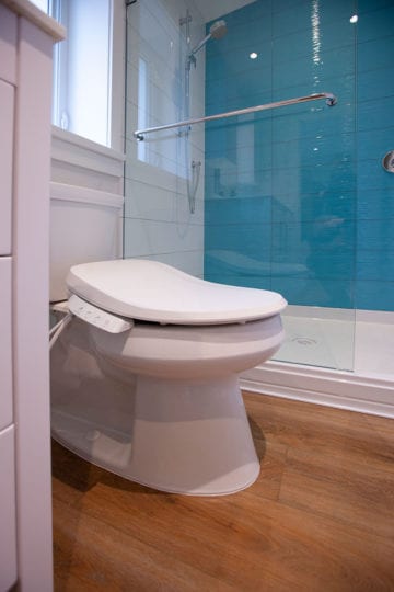 cleaning toilet next to the full size shower