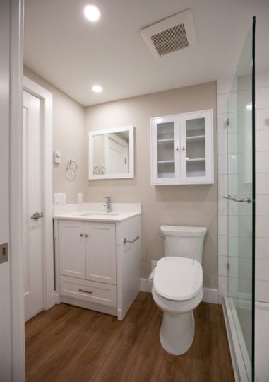 Bathroom with vanity, toilet and full height shower