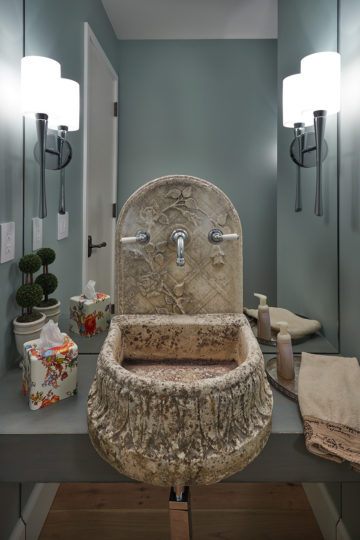 Grecian-style classic-inspired stone sculpted sink with climbing rose and lattice pattern.