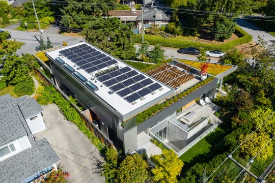 Aerial view of upper patio and deck with custom trellis, solar panels and green roof
