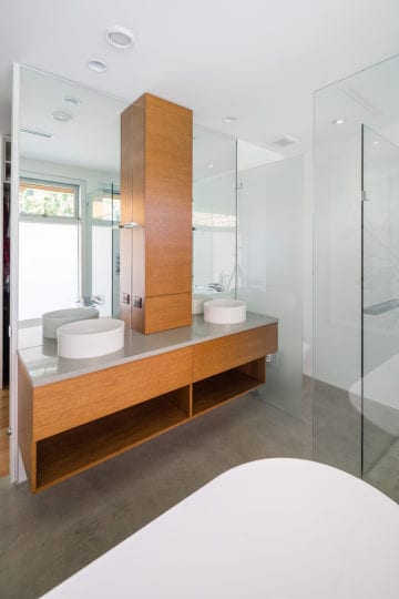 Modern style custom bathroom with two sinks and bathtub.