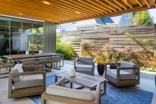 Stunning luxury living space with tall wooden fence in Vancouver home by Barrett Group.