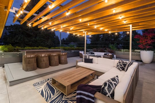Outdoor patio furniture on private balcony by Barrett Group Custom Builders.