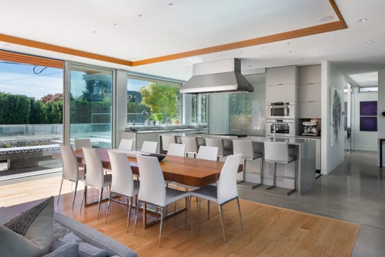 Open-concept, modern dining area with on hardwood floor in custom-built North Vancouver home.