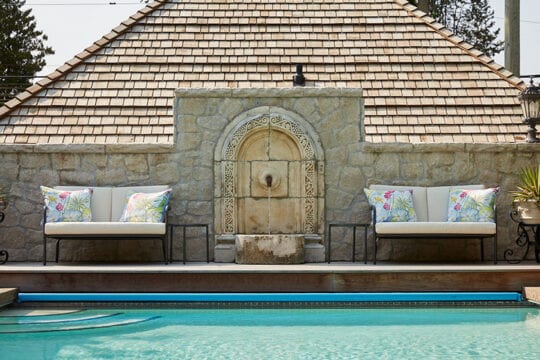 Wide shot of the old world fountain at the pool's edge